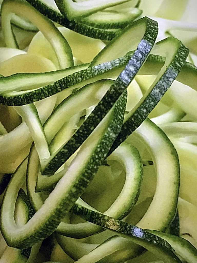 Colorful skinny ribbons of zucchini are long and unbroken